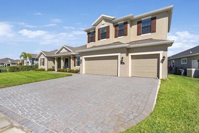 view of front of property with a garage and a front lawn