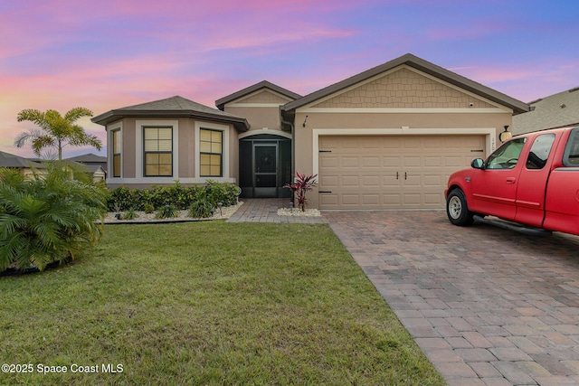 view of front of house with a yard and a garage