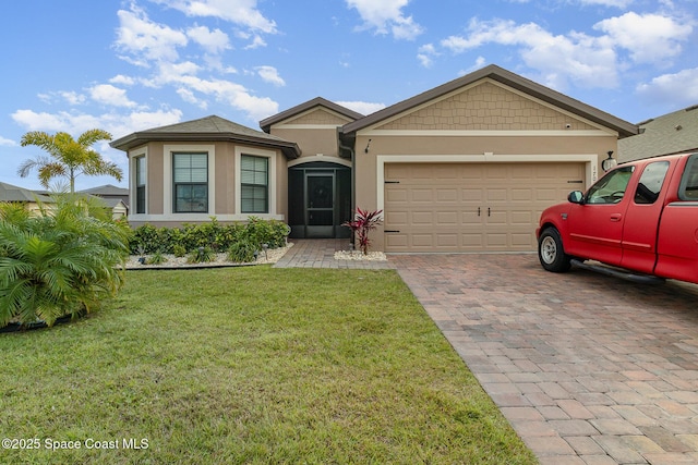 view of front of home featuring a garage and a front lawn