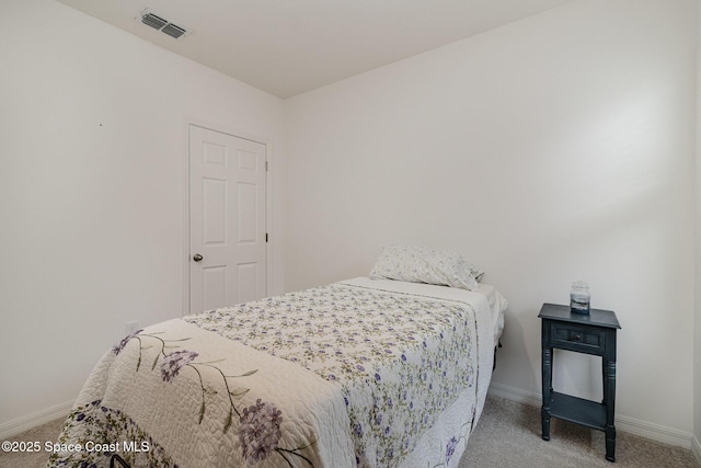 bedroom with light colored carpet