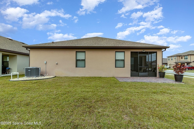 back of house featuring a lawn, a patio, and central air condition unit