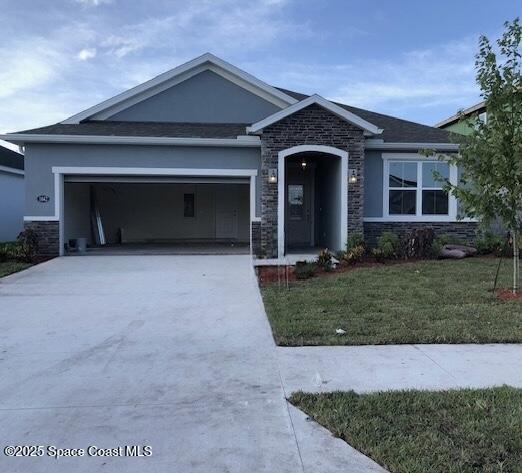 view of front of property with a front yard and a garage