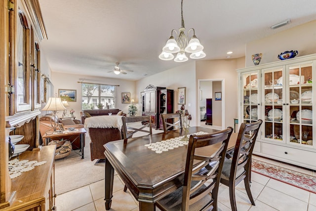 dining space featuring ceiling fan with notable chandelier and light tile patterned floors