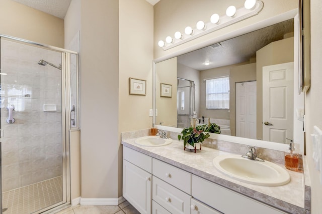 bathroom with walk in shower, tile patterned floors, and vanity