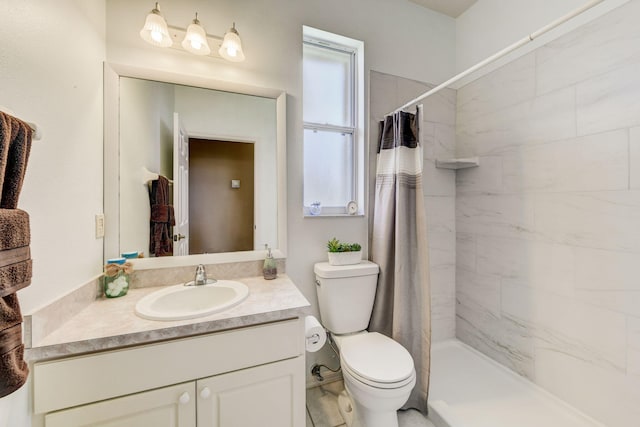 bathroom featuring vanity, walk in shower, and toilet