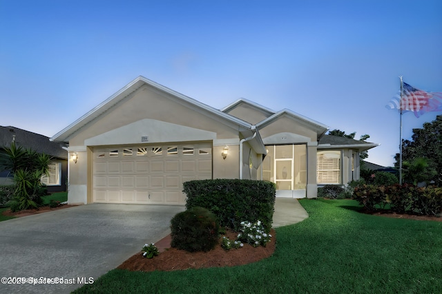 ranch-style home with a yard and a garage