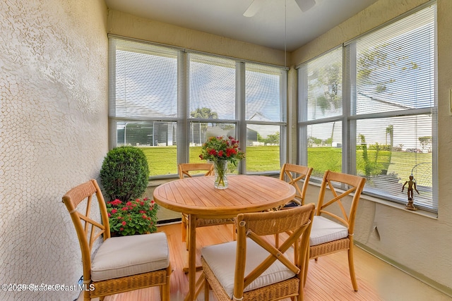 sunroom featuring ceiling fan