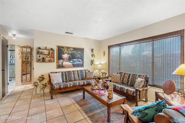 tiled living room with a textured ceiling