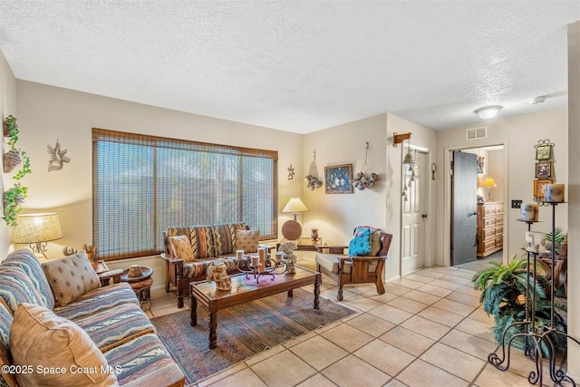 living room featuring light tile patterned floors and a textured ceiling