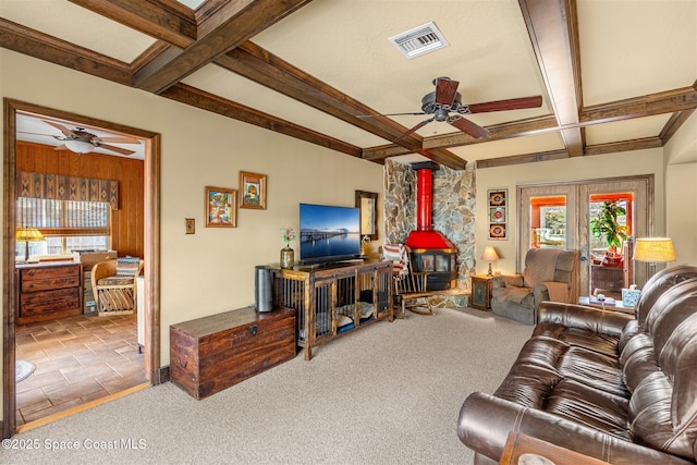 living room with coffered ceiling, carpet, french doors, and a wood stove