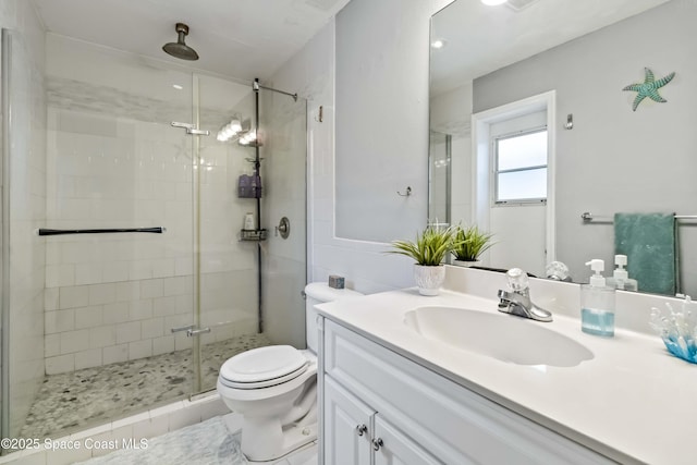 bathroom featuring vanity, toilet, tile patterned floors, and a shower with door