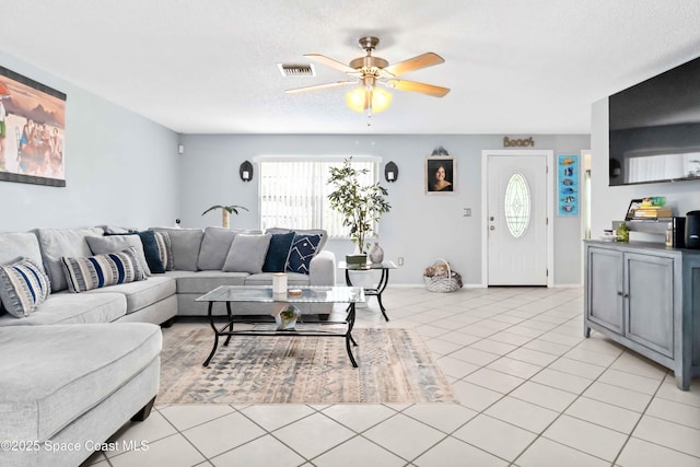 tiled living room featuring a textured ceiling and ceiling fan