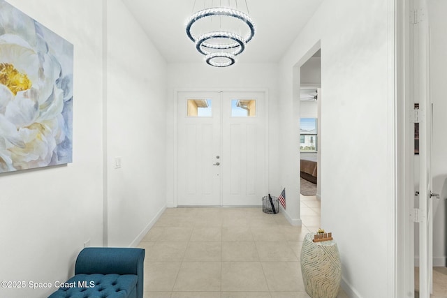 tiled foyer entrance featuring a chandelier