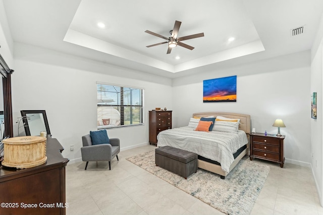 bedroom featuring ceiling fan and a raised ceiling