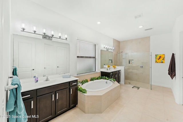 bathroom featuring tile patterned flooring, shower with separate bathtub, and vanity