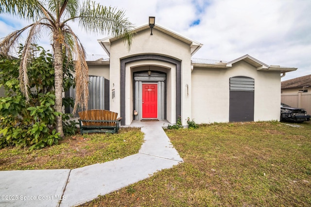 entrance to property with a lawn