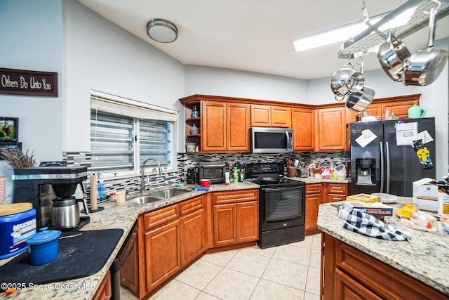 kitchen with sink, light tile patterned floors, tasteful backsplash, and black appliances