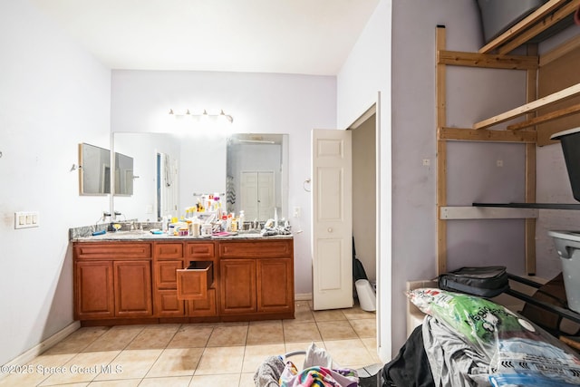 bathroom featuring tile patterned flooring, vanity, and toilet