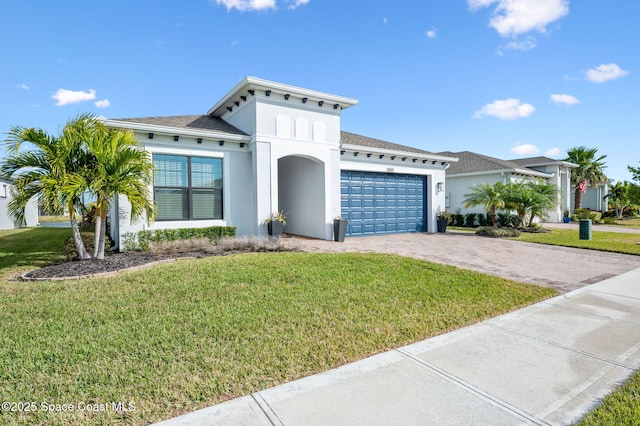 mediterranean / spanish house featuring a garage and a front yard