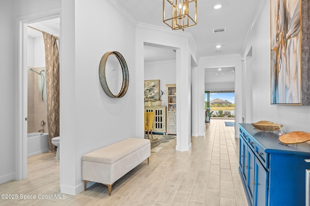 corridor with an inviting chandelier and ornamental molding