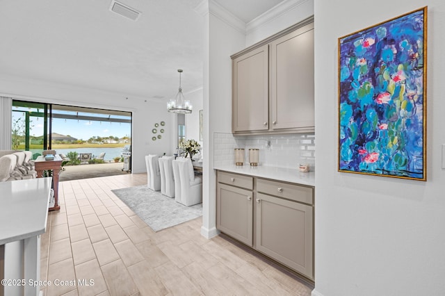 kitchen with decorative backsplash, gray cabinets, and a water view