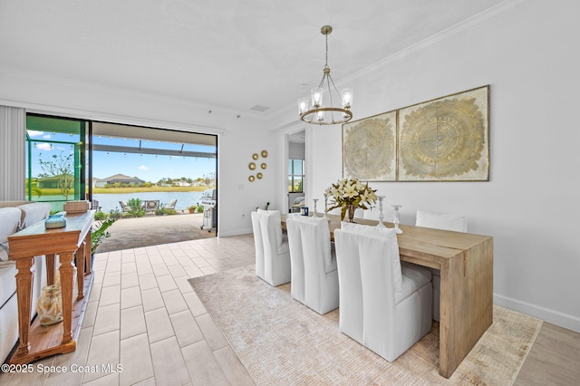 dining area with a water view, an inviting chandelier, and ornamental molding