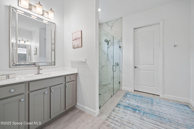 bathroom with an enclosed shower, vanity, and hardwood / wood-style flooring