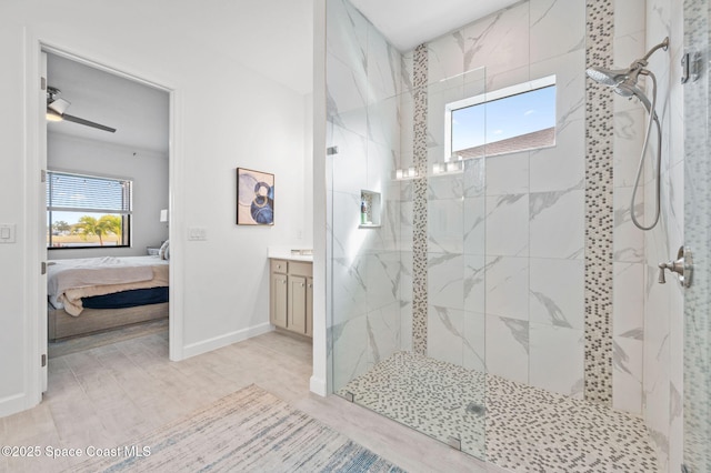 bathroom with wood-type flooring, plenty of natural light, and tiled shower