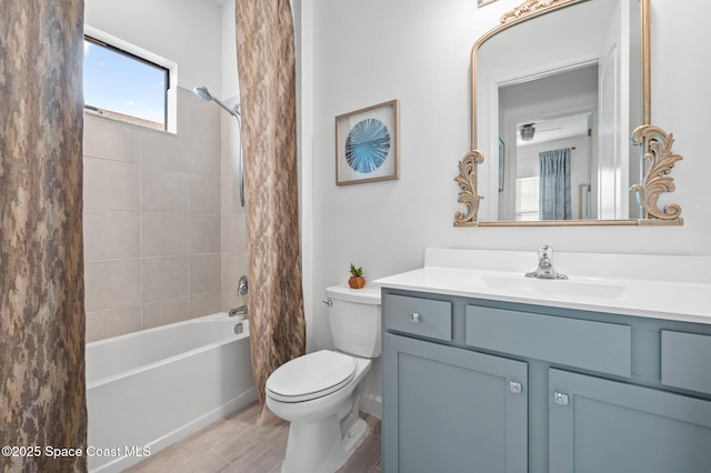 full bathroom featuring toilet, vanity, wood-type flooring, and shower / bathtub combination with curtain