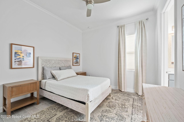 bedroom featuring ceiling fan, ensuite bathroom, and crown molding