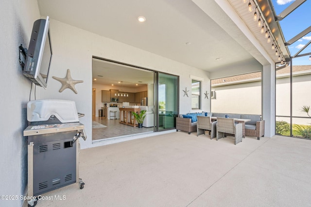 view of patio / terrace featuring an outdoor living space and glass enclosure