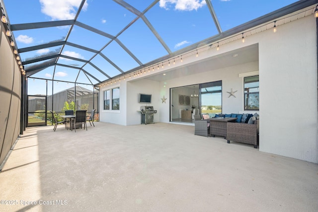 view of patio featuring grilling area, an outdoor living space, and glass enclosure