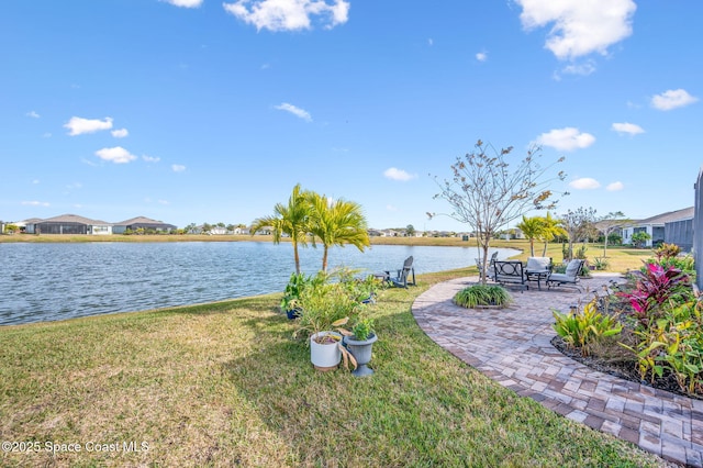 view of yard featuring a water view and a patio