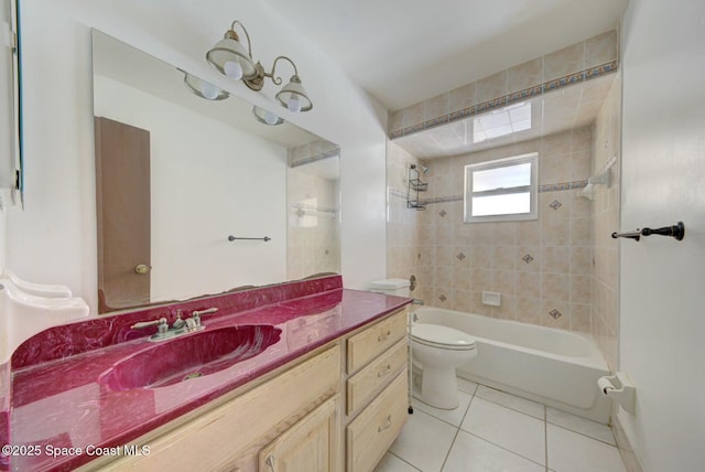 full bathroom featuring tiled shower / bath, tile patterned flooring, vanity, and toilet