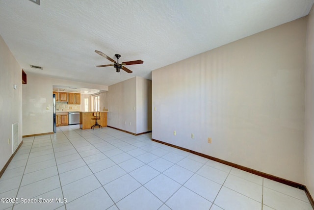 unfurnished living room featuring ceiling fan, a textured ceiling, and light tile patterned floors