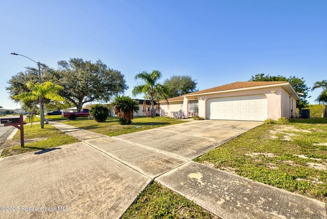 ranch-style home featuring a garage and a front lawn