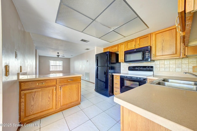 kitchen with kitchen peninsula, black appliances, decorative backsplash, ceiling fan, and sink