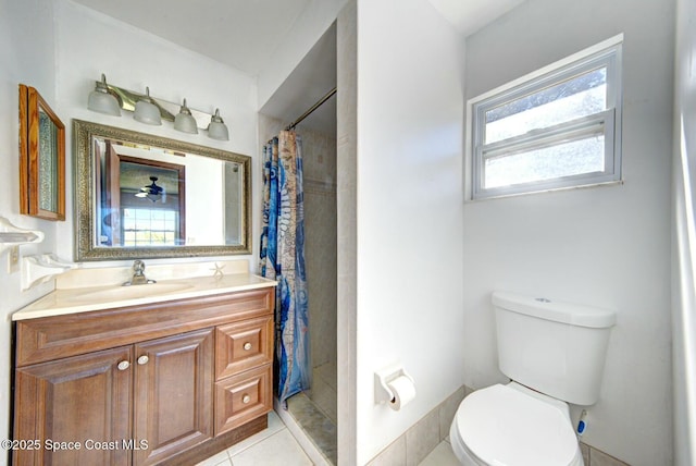 bathroom with toilet, walk in shower, vanity, tile patterned floors, and ceiling fan