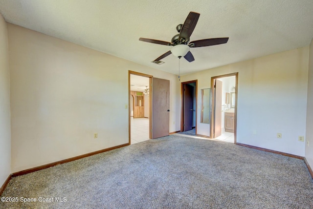 unfurnished bedroom featuring a textured ceiling, ceiling fan, light carpet, and connected bathroom