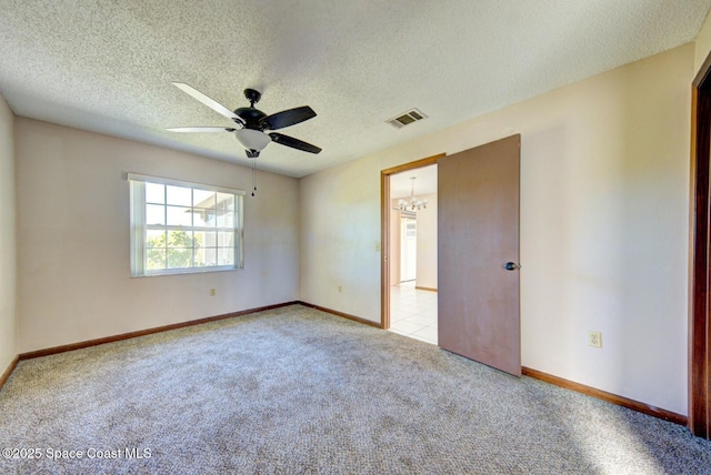 unfurnished room featuring a textured ceiling, light carpet, and ceiling fan with notable chandelier