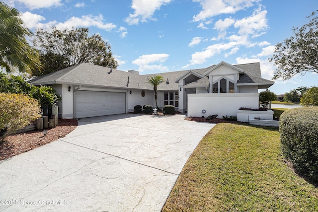 ranch-style home featuring a garage and a front lawn