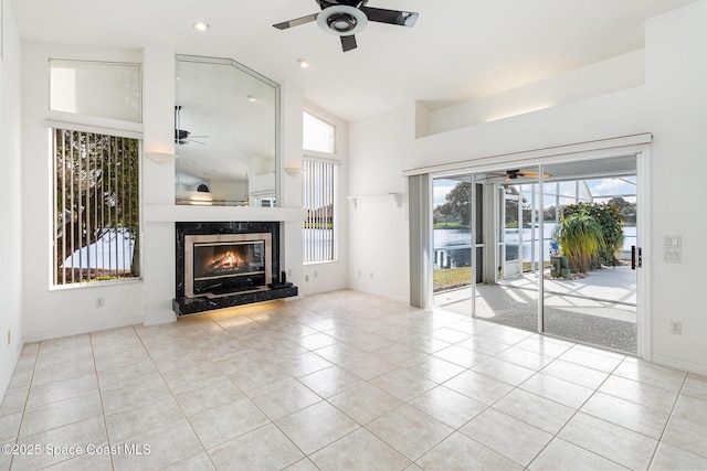 unfurnished living room featuring a high end fireplace and light tile patterned flooring