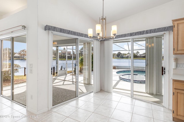 unfurnished dining area featuring vaulted ceiling, an inviting chandelier, light tile patterned floors, and a water view