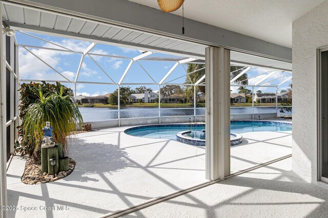 view of swimming pool with glass enclosure, an in ground hot tub, a water view, and a patio