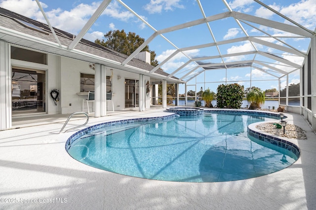 view of pool featuring a lanai, a patio area, and an in ground hot tub