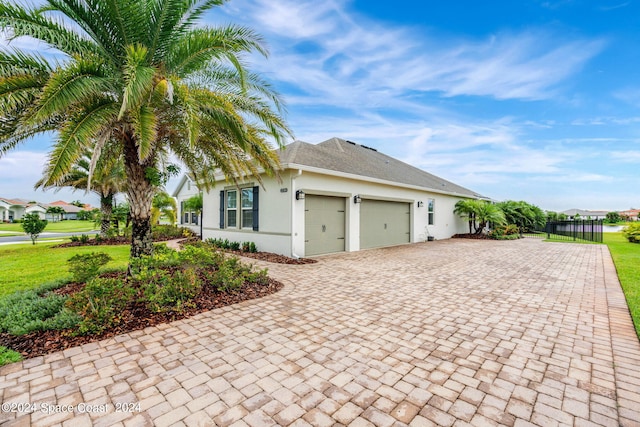 view of side of home with a garage and a yard