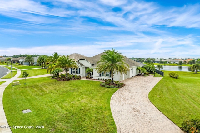 ranch-style house with a front lawn and a water view