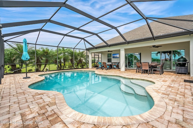 view of pool with a lanai, ceiling fan, and a patio area