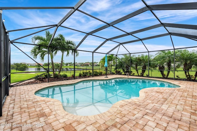 view of swimming pool with a lanai and a patio