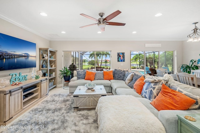 living room with ornamental molding and ceiling fan with notable chandelier